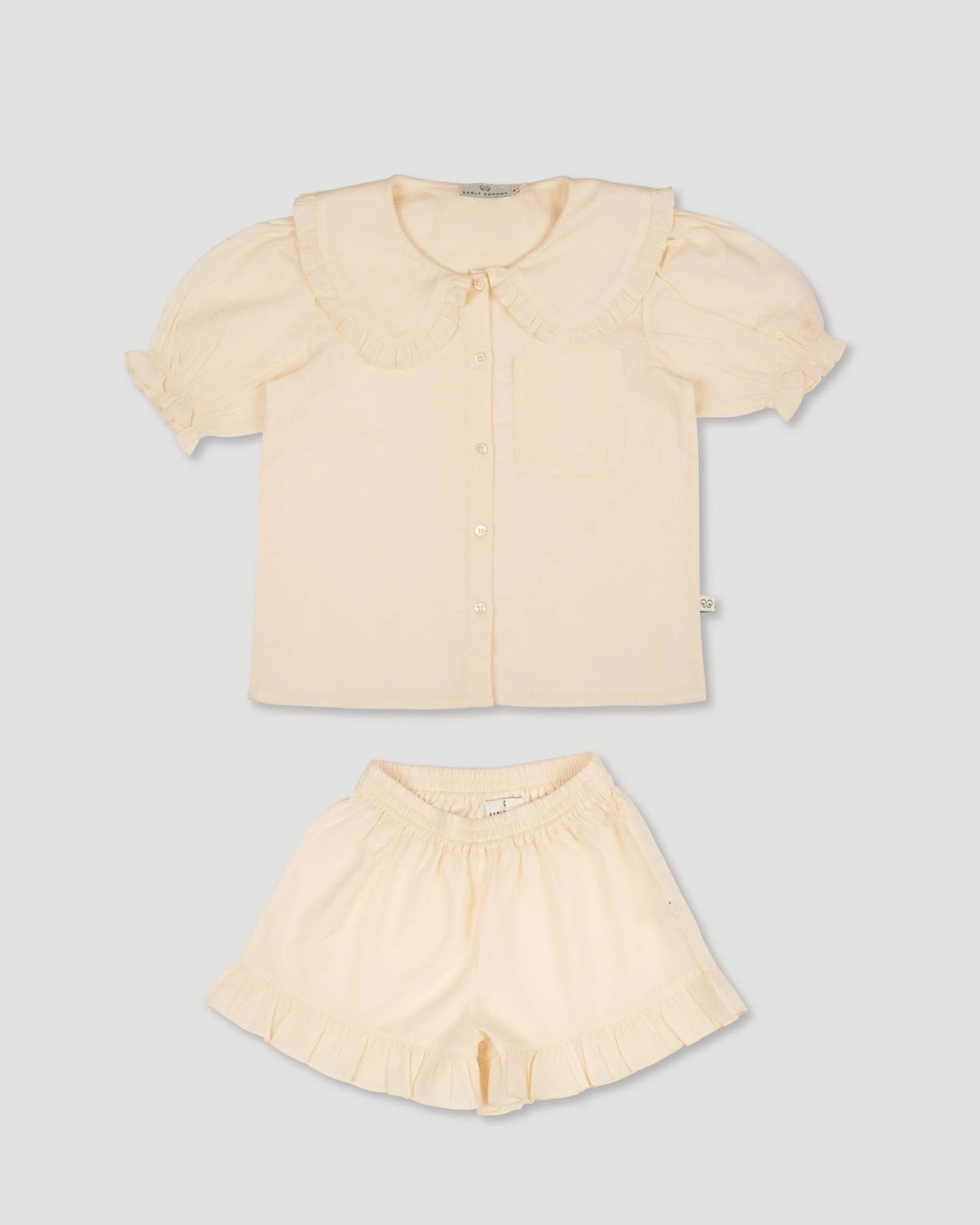 Early Sunday, Peggy Pyjama Set in Hazelnut Cream, made from Dyed Cotton Swiss Dobby Tiny Dots fabric, featuring Button-down shirt with classic tailoring, subtle gathers, and gentle volume, shown in a front flat-lay view