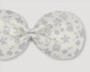 Early Sunday, Penelope Alligator Clip in Mini Flower print, made from Printed canvas 70% Cotton 30% Linen fabric, featuring a fabric bow design with a secure hair clip fastening, shown in a closeup flat-lay view