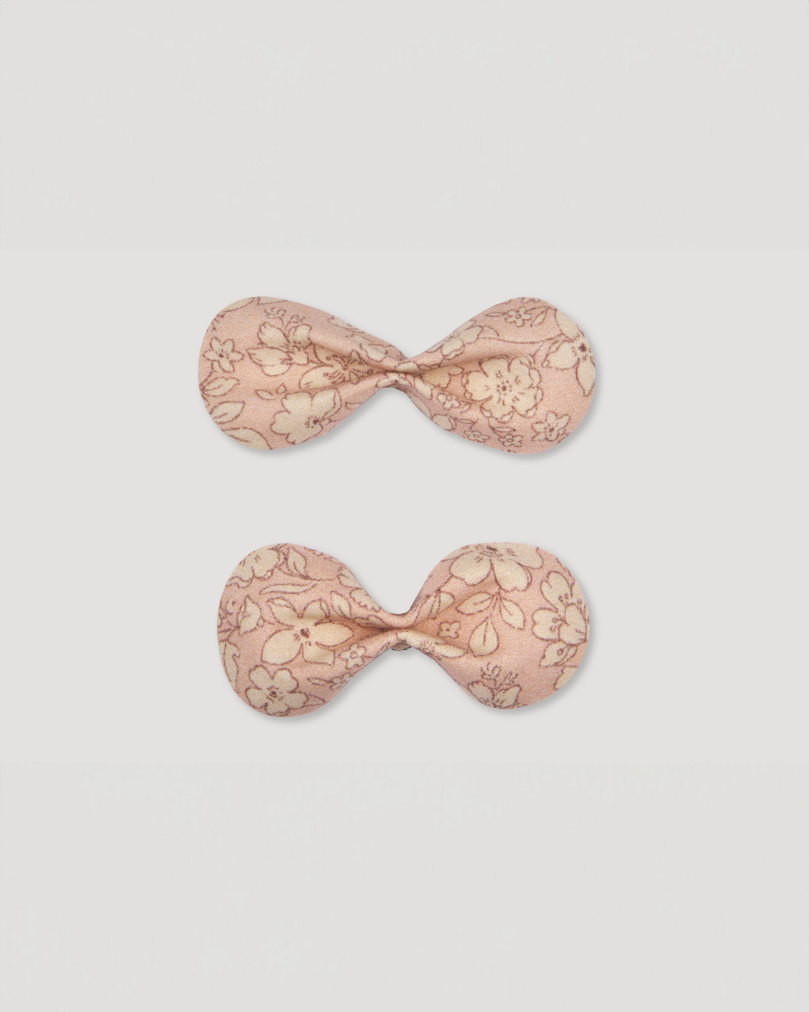 Early Sunday, Penelope Alligator Clip in Garden flower print, made from Printed Cotton Cambric fabric, featuring a bow design on an alligator clip with a secure fit, shown in a front flat-lay view