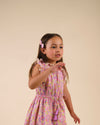 Early Sunday, Penelope Clip in Emma Floral Purple color, made from Organic Printed Cotton Cambric fabric, featuring a set of two bow clips with a secure fit, shown in side view of model wearing it