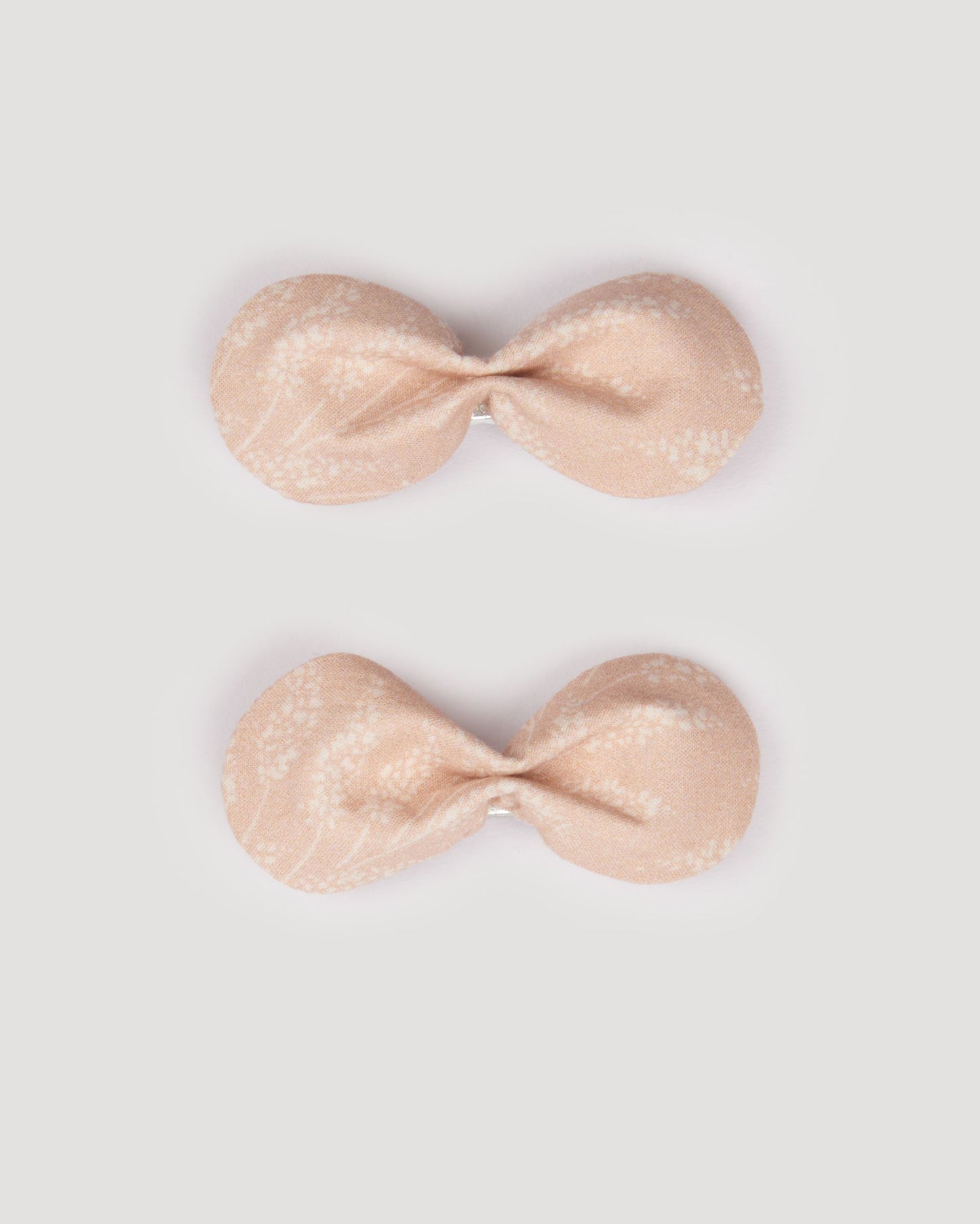 Early Sunday, Penelope Clip in Feather print, made from Printed 60s Cotton Cambric fabric, featuring a set of two bow clips with a secure fit, shown in a front flat-lay view