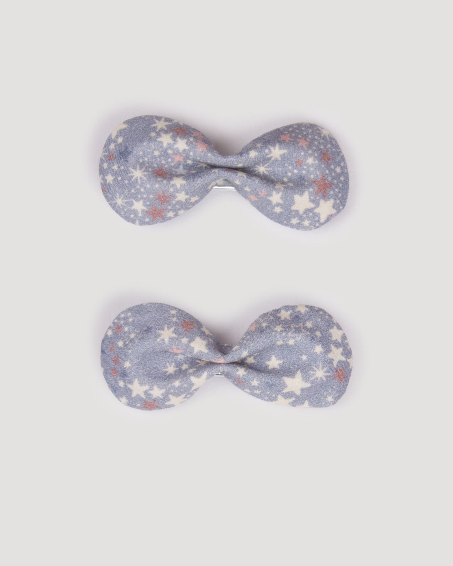 Early Sunday, Penelope Clip in Celestial print, made from Printed 60s Cotton Satin fabric, featuring a set of two bow clips with a secure fit, shown in a front flat-lay view