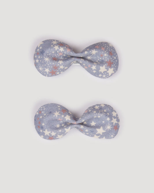 Early Sunday, Penelope Clip in Celestial print, made from Printed 60s Cotton Satin fabric, featuring a set of two bow clips with a secure fit, shown in a front flat-lay view