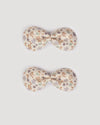 Early Sunday, Penelope Clip in Mini Flowers print, made from Printed 60s Cotton Satin fabric, featuring a set of two bow clips with a secure fit, shown in a front flat-lay view