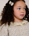 Early Sunday, Penelope Clip in Mini Flowers print, made from Printed 60s Cotton Satin fabric, featuring a set of two bow clips with a secure fit, shown in a close-up shot of a model wearing it