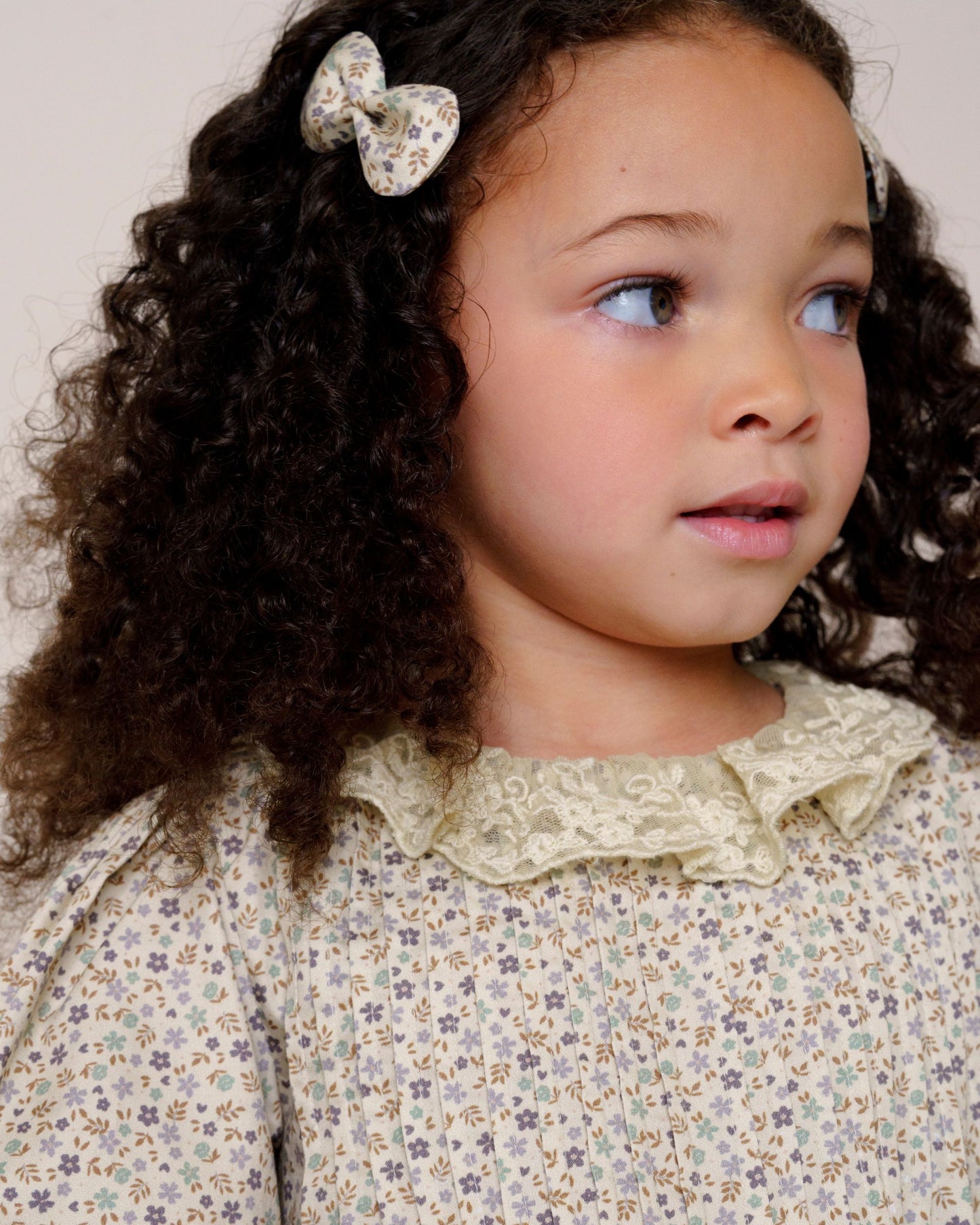 Early Sunday, Penelope Clip in Mini Flowers print, made from Printed 60s Cotton Satin fabric, featuring a set of two bow clips with a secure fit, shown in a close-up shot of a model wearing it