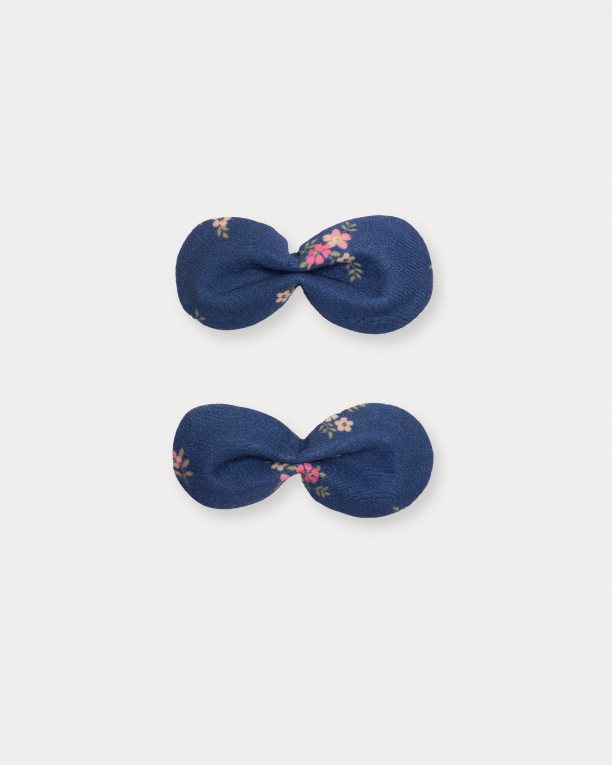 Early Sunday, Penelope Clip in Ditsy Bouquet Navy Blue, made from Printed Cotton Satin fabric, featuring a set of two bow clips with a secure fit, shown in a front flat-lay view