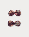 Early Sunday, Penelope Clip in Garden Flowers Plum, made from Printed Cotton Satin fabric, featuring a set of two bow clips with a secure fit, shown in a front flat-lay view