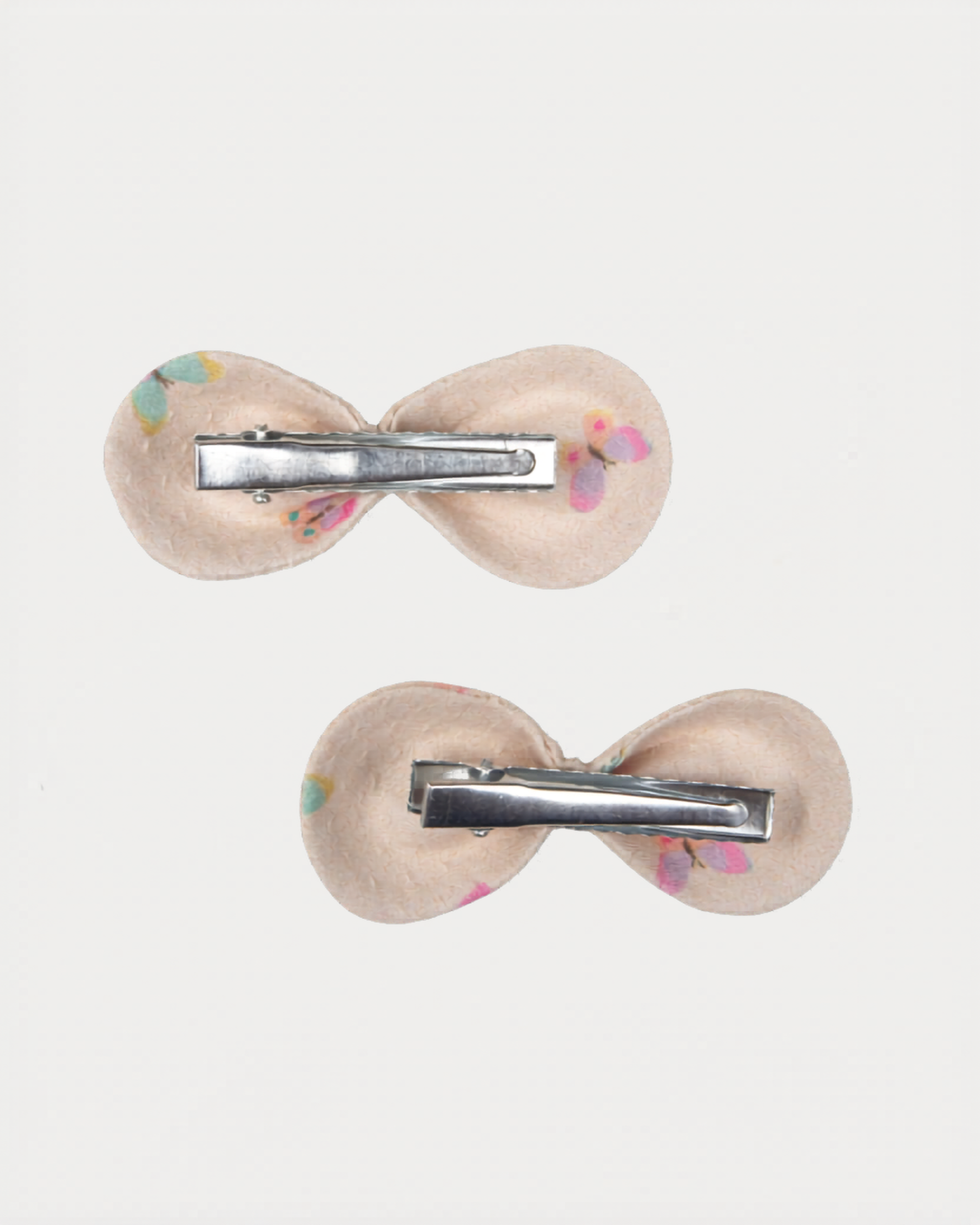 Early Sunday, Penelope Clip in Butterflies print, made from Printed Cotton Tiny Swiss Dobby fabric, featuring a set of two bow clips with a secure fit, shown in a back flat-lay view