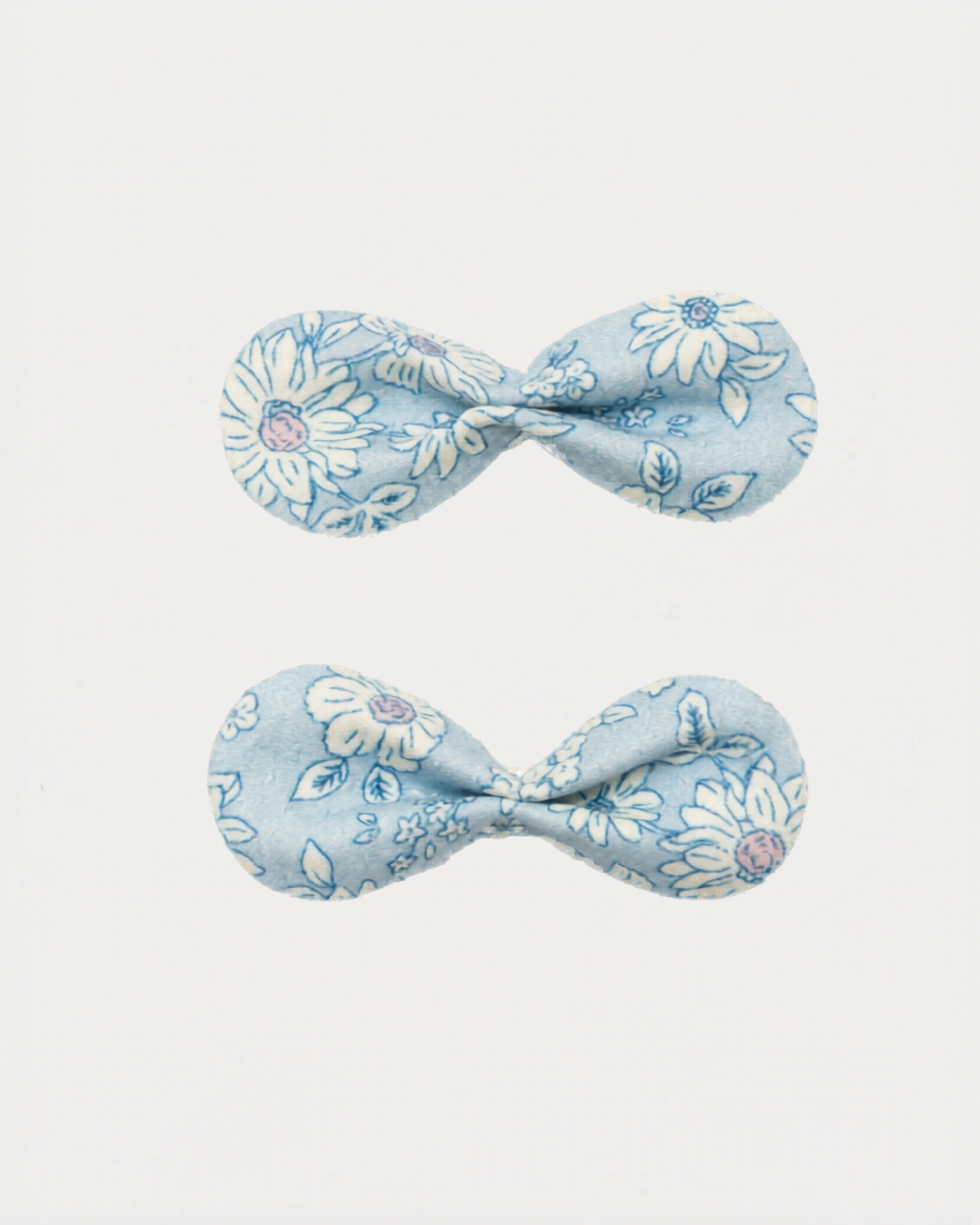 Early Sunday, Penelope Clip in Tonal Floral Blue color, made from Printed Cotton Tiny Swiss Dobby fabric, featuring a set of two bow clips with a secure fit, shown in closeup flat-lay view