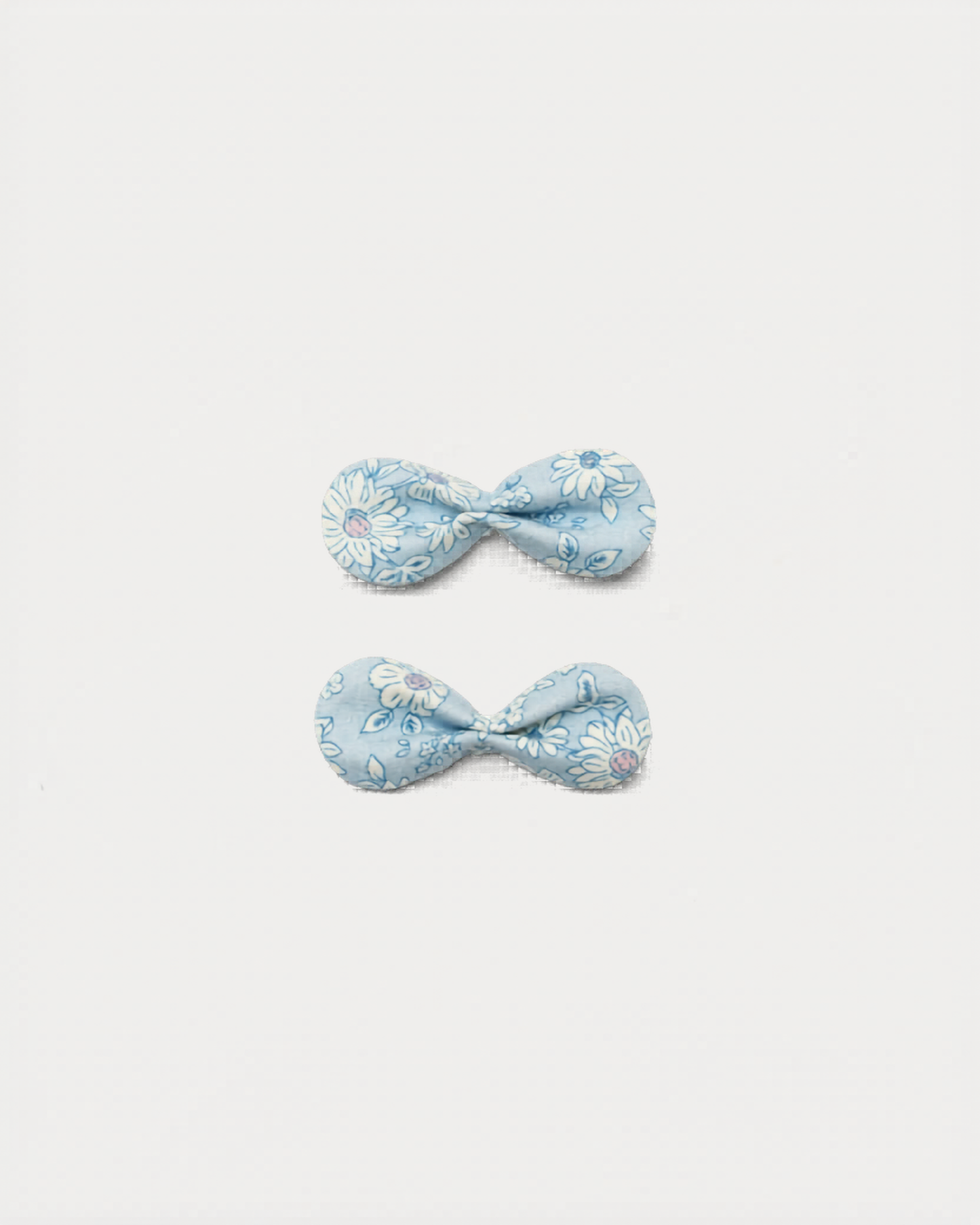 Early Sunday, Penelope Clip in Tonal Floral Blue color, made from Printed Cotton Tiny Swiss Dobby fabric, featuring a set of two bow clips with a secure fit, shown in front flat-lay view