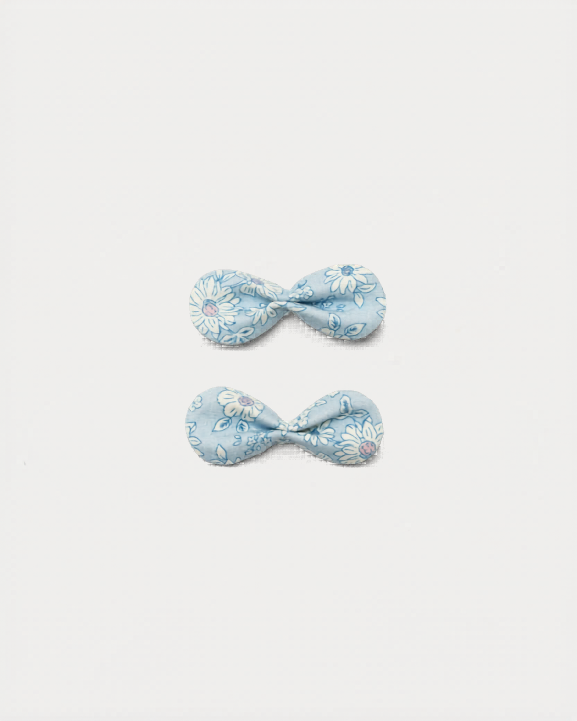 Early Sunday, Penelope Clip in Tonal Floral Blue color, made from Printed Cotton Tiny Swiss Dobby fabric, featuring a set of two bow clips with a secure fit, shown in front flat-lay view