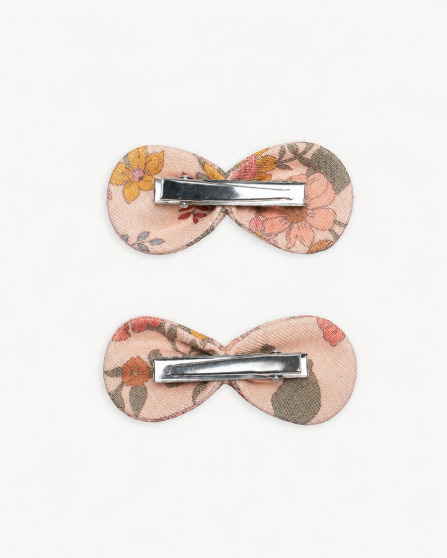 Early Sunday, Penelope Clip in Bloom Blush, made from Printed Viscose Twill fabric, featuring a set of two bow clips with a secure fit, shown in a back flat-lay view