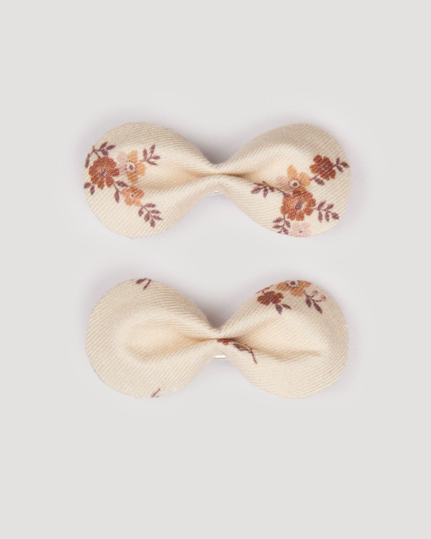 Early Sunday, Penelope Clip in Ditsy Bouquet Cream print, made from Printed Viscose Twill fabric, featuring a set of two bow clips with a secure fit, shown in a front flat-lay view