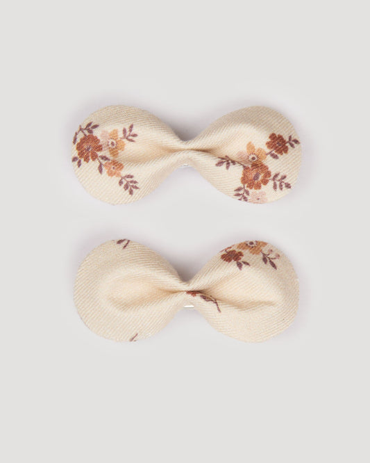 Early Sunday, Penelope Clip in Ditsy Bouquet Cream print, made from Printed Viscose Twill fabric, featuring a set of two bow clips with a secure fit, shown in a front flat-lay view