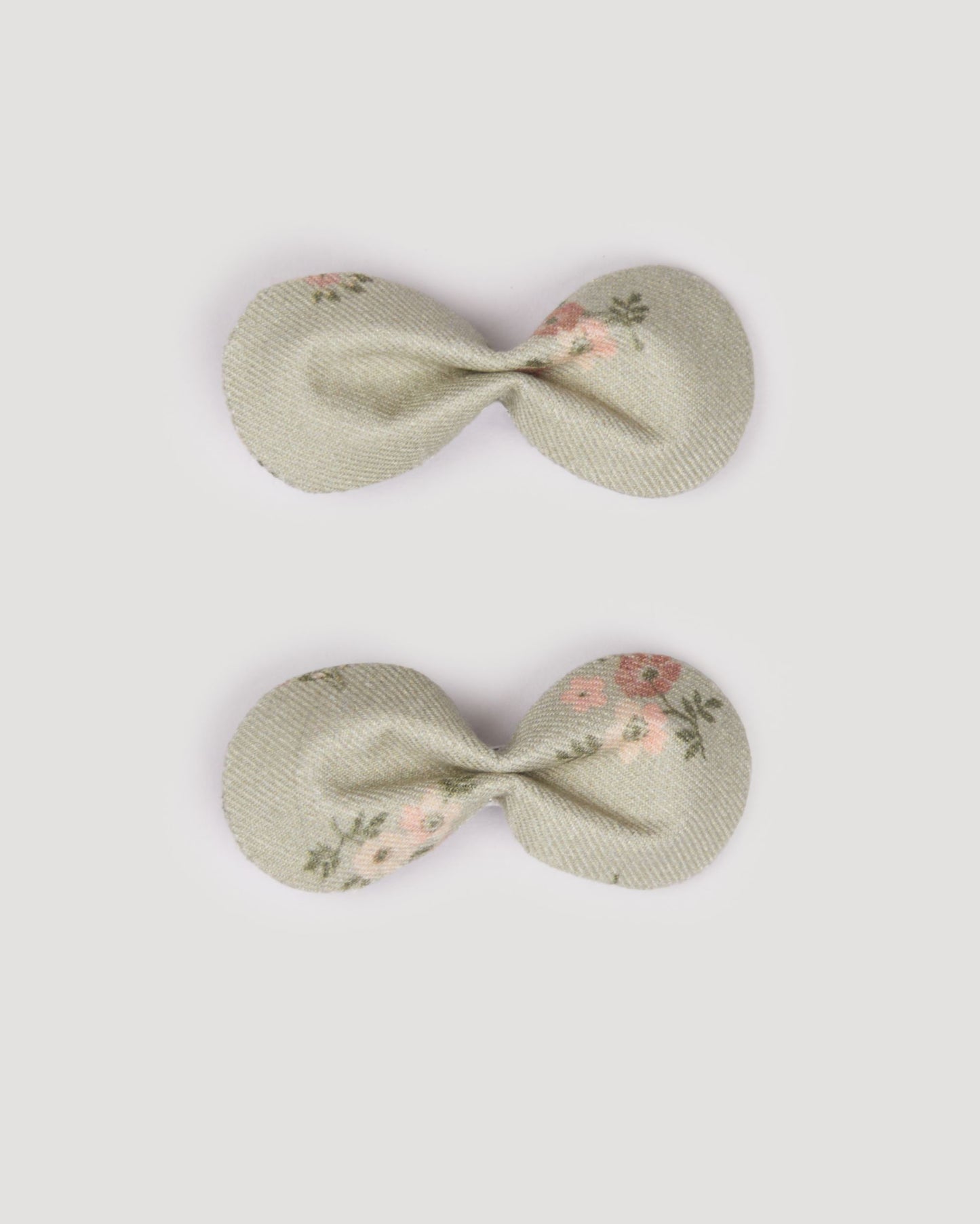 Early Sunday, Penelope Clip in Ditsy Bouquet Jade print, made from Printed Viscose Twill fabric, featuring a set of two bow clips with a secure fit, shown in a front flat-lay view