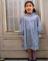 Early Sunday, Penelope Dress in Celestial print, made from Printed Cotton Satin fabric, featuring Hand-embroidered floral motifs, shown in a front view of a model wearing it in a studio setting