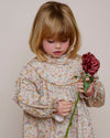 Early Sunday, Penelope Dress in Floral print, made from Printed Cotton Satin fabric, featuring Hand-embroidered floral motifs, shown in a close up shot of model wearing it