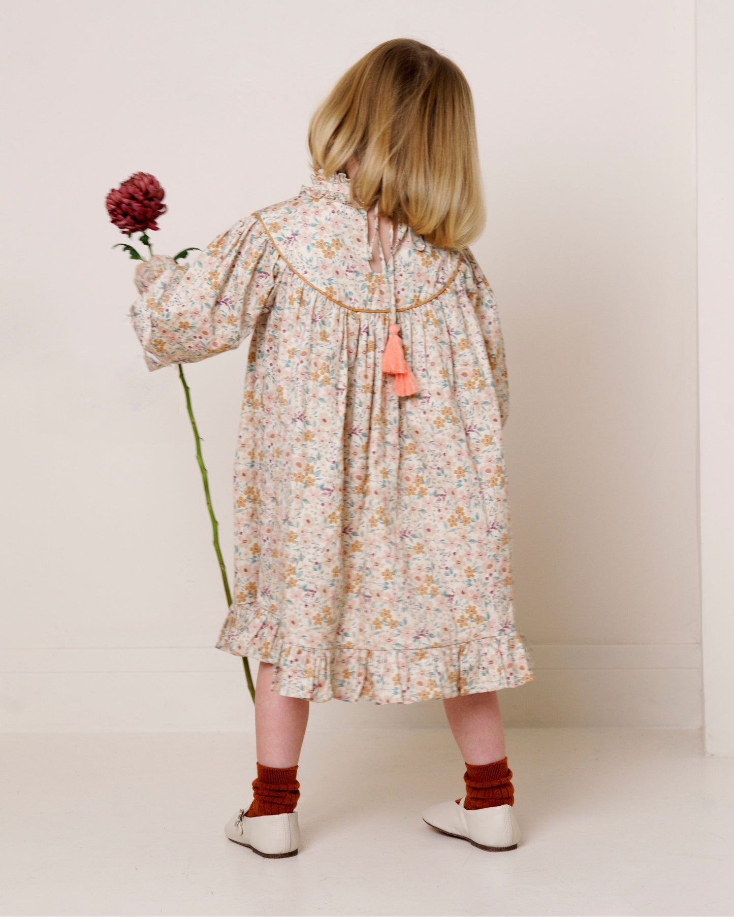 Early Sunday, Penelope Dress in Floral print, made from Printed Cotton Satin fabric, featuring Hand-embroidered floral motifs, shown in a back view of model wearing it