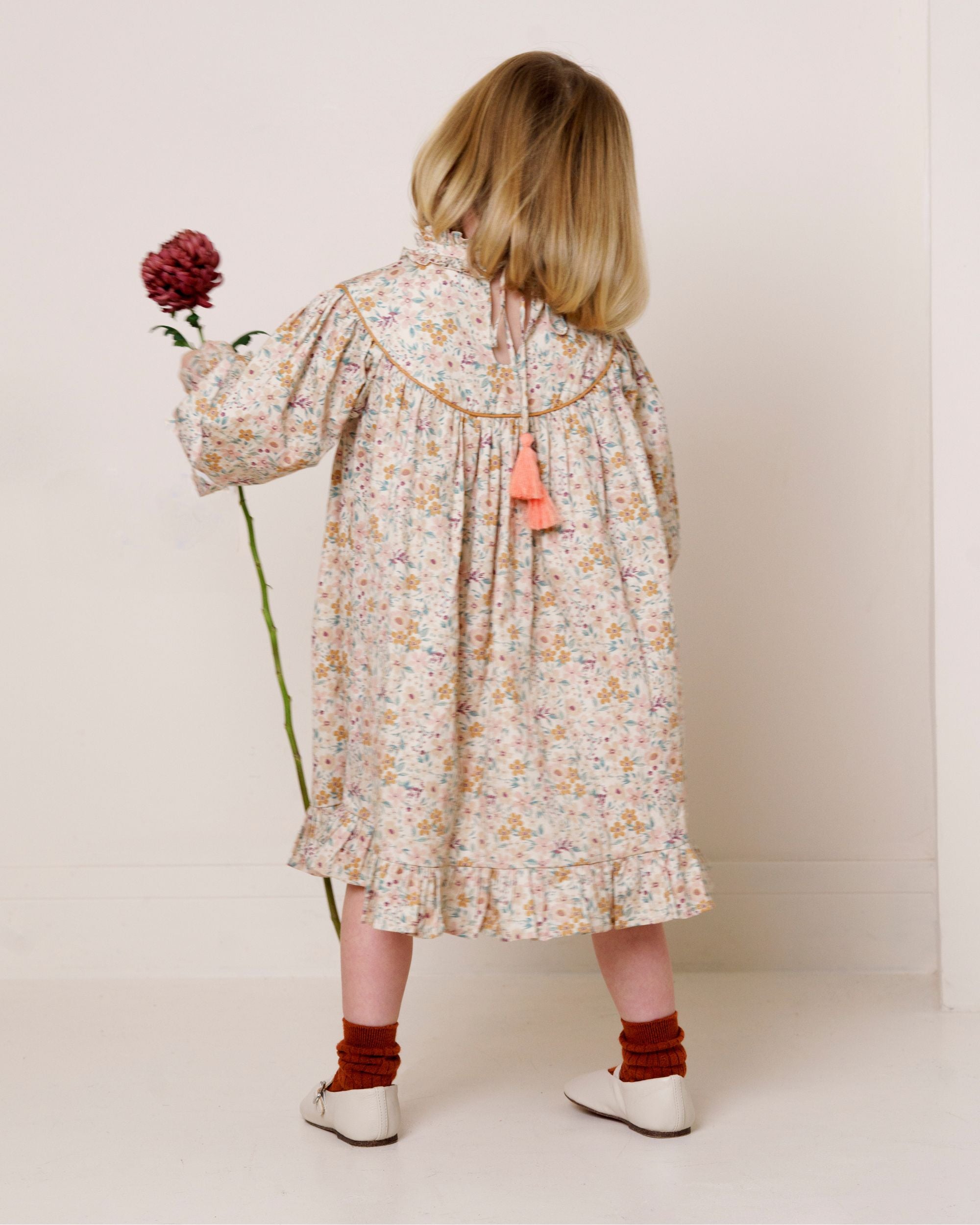 Early Sunday, Penelope Dress in Floral print, made from Printed Cotton Satin fabric, featuring Hand-embroidered floral motifs, shown in a back view of model wearing it