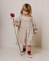 Early Sunday, Penelope Dress in Floral print, made from Printed Cotton Satin fabric, featuring Hand-embroidered floral motifs, shown in a front view of a model wearing it in a studio setting
