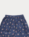 Early Sunday, Poppy Baby Bloomer Trousers in Ditsy Bouquet Navy, made from Printed Cotton Satin fabric, featuring an elasticated waistband & ruffled cuffs at the ankles, shown in a closeup flat-lay view