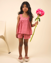 Early Sunday, Roman Cotton Linen Dyed Fabric Short in Peony color, made from 70% Cotton 30% Linen fabric, featuring a relaxed silhouette with a comfortable elastic waistband, shown in a front view of model in a studio setting