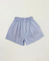 Early Sunday, Roman Short in Summer Sky color, made from 100% Cotton Chambray fabric, featuring a relaxed fit with an elastic waistband & beautiful embroidery, shown in a back flat-lay view