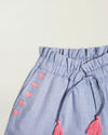 Early Sunday, Roman Short in Summer Sky color, made from 100% Cotton Chambray fabric, featuring a relaxed fit with an elastic waistband & beautiful embroidery, shown in a closeup flat-lay view