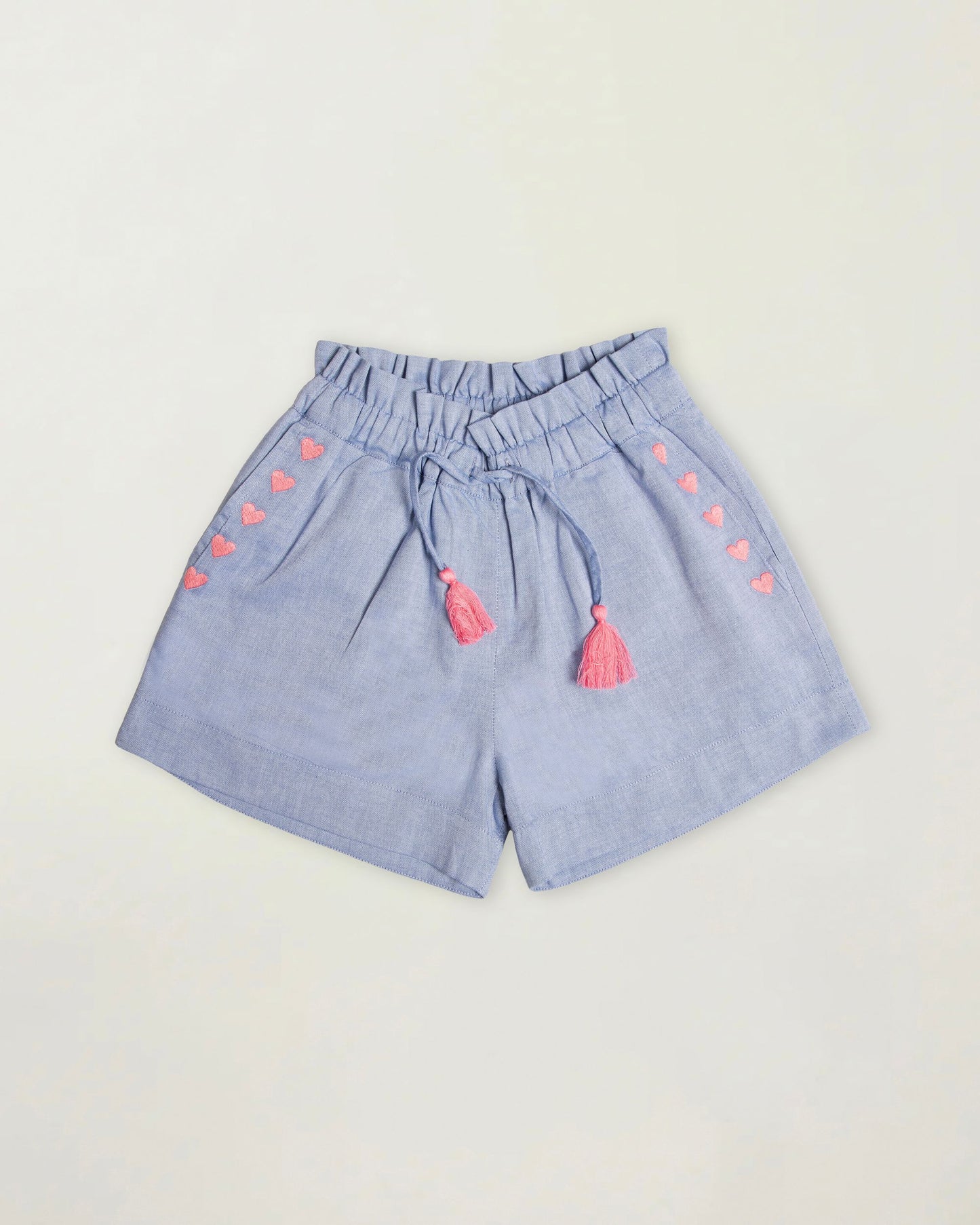 Early Sunday, Roman Short in Summer Sky color, made from 100% Cotton Chambray fabric, featuring a relaxed fit with an elastic waistband & beautiful embroidery, shown in a front flat-lay view