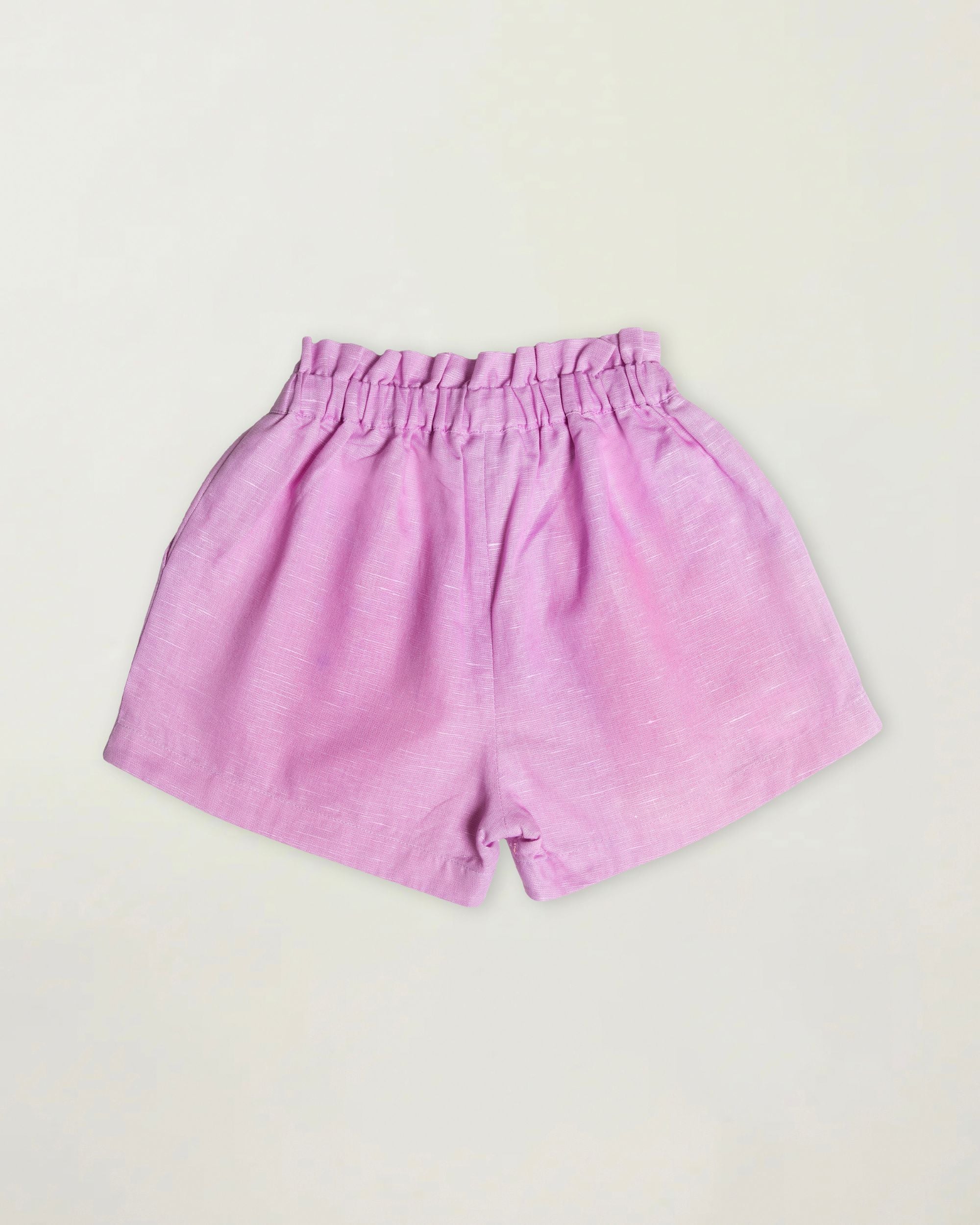 Early Sunday, Roman Short in Lilac color, made from 70% Cotton 30% Linen fabric, featuring a relaxed fit with an elastic waistband & beautiful embroidery, shown in a back flat-lay view