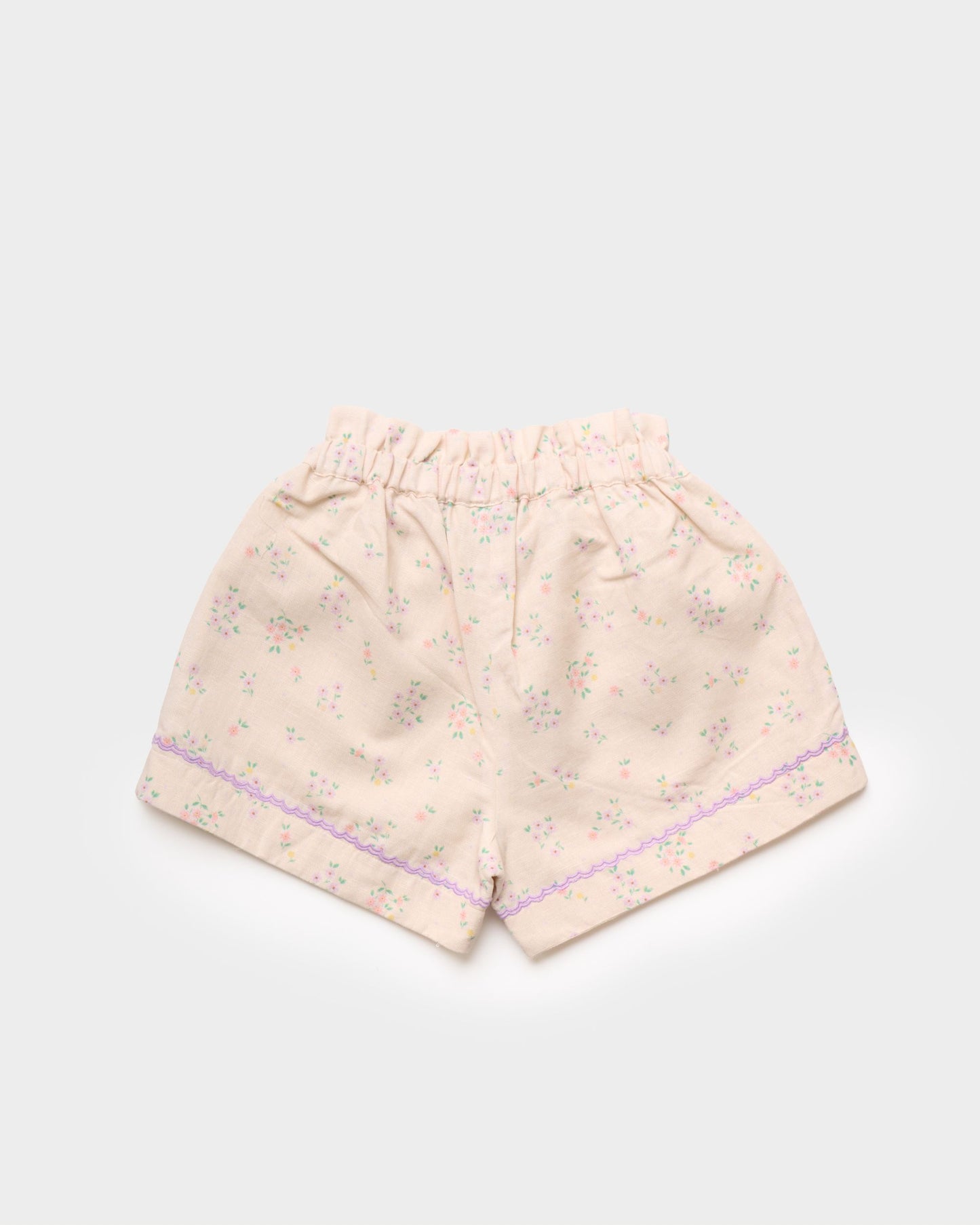 Early Sunday, Roman Short in Painted Bouquet print, made from 70% Cotton 30% Linen fabric, featuring a relaxed fit with an elastic waistband & floral design, shown in a back flat-lay view