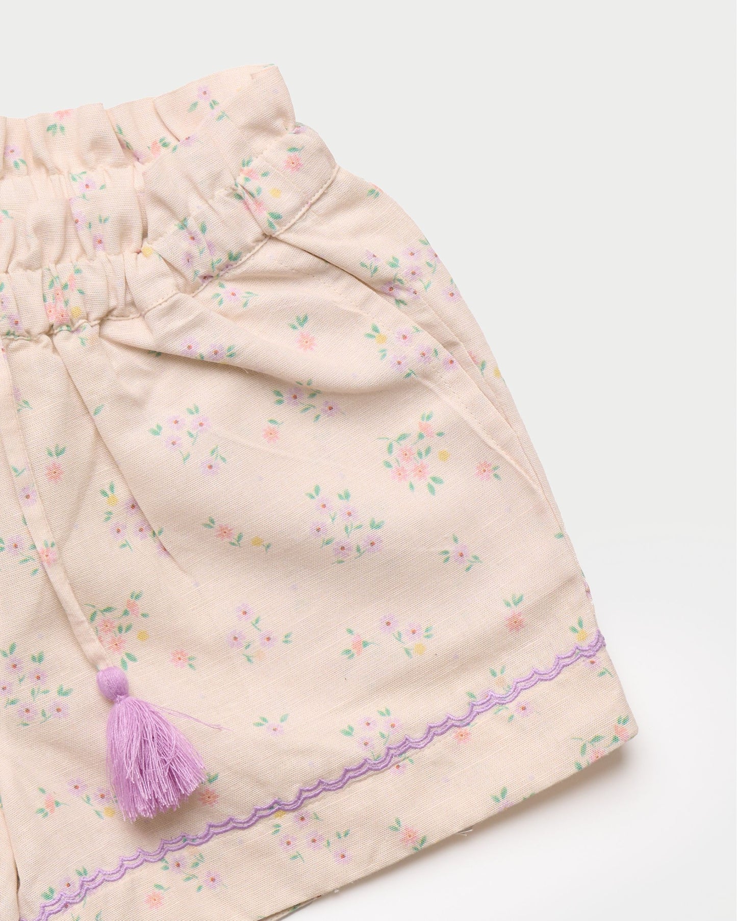 Early Sunday, Roman Short in Painted Bouquet print, made from 70% Cotton 30% Linen fabric, featuring a relaxed fit with an elastic waistband & floral design, shown in a closeup flat-lay view