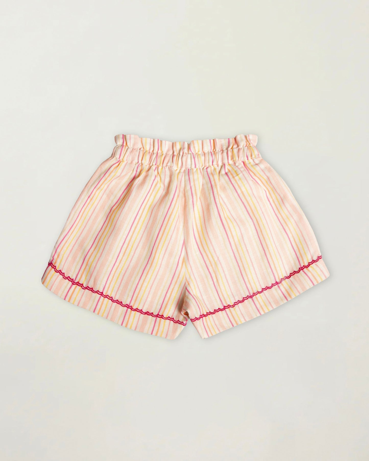 Early Sunday, Roman Short in Pink Strips print, made from 70% Cotton 30% Linen fabric, featuring a relaxed fit with an elastic waistband & striped design, shown in a back flat-lay view