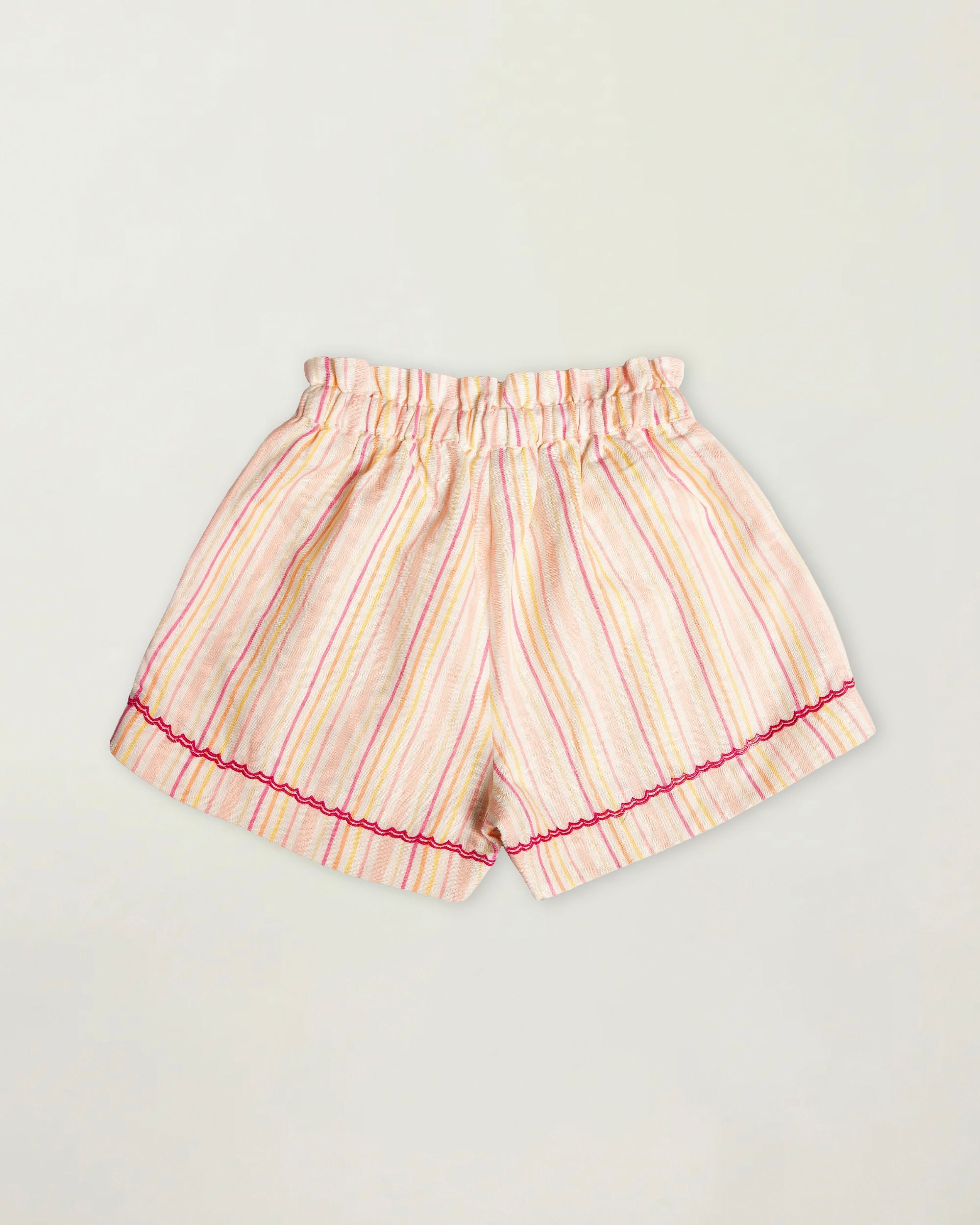 Early Sunday, Roman Short in Pink Strips print, made from 70% Cotton 30% Linen fabric, featuring a relaxed fit with an elastic waistband & striped design, shown in a back flat-lay view