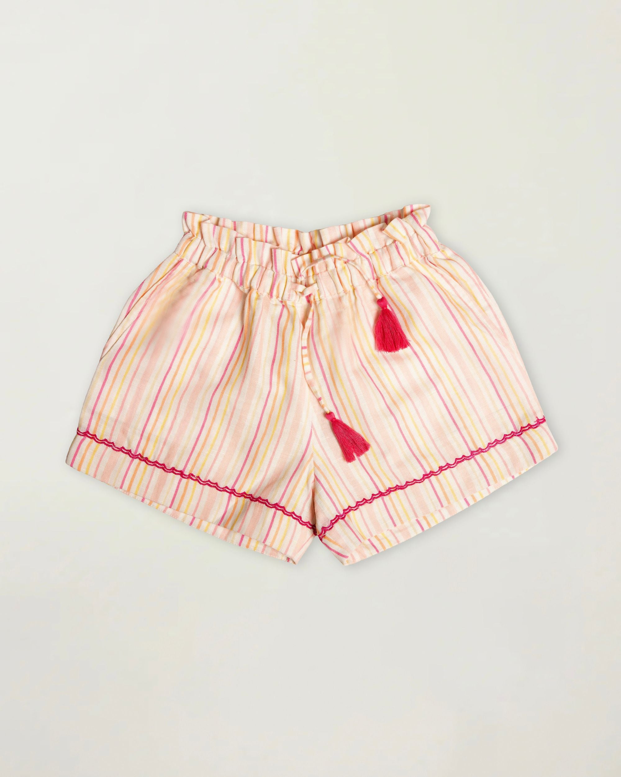 Early Sunday, Roman Short in Pink Strips print, made from 70% Cotton 30% Linen fabric, featuring a relaxed fit with an elastic waistband & striped design, shown in a front flat-lay view