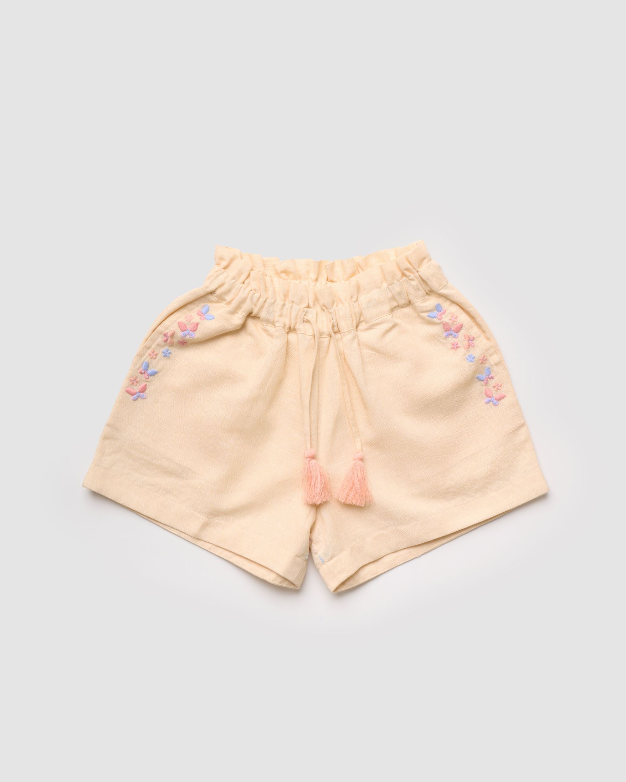 Early Sunday, Roman Short in Sand color, made from 70% Cotton 30% Linen fabric, featuring a relaxed fit with an elastic waistband & beautiful embroidery, shown in a front flat-lay view