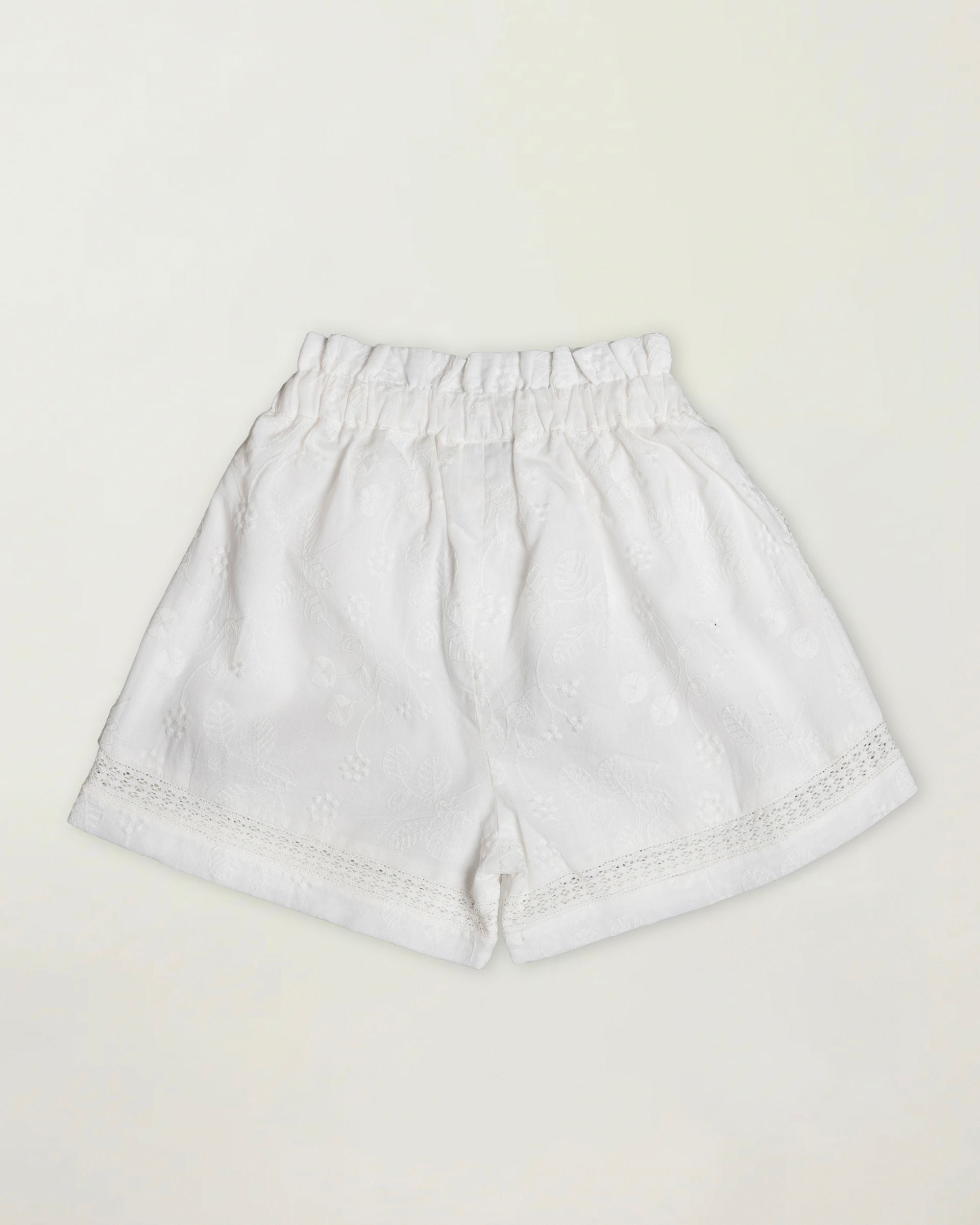 Early Sunday, Roman Short in Ivory color, made from All Over Embroidery fabric, featuring a relaxed fit with an elastic waistband & beautiful embroidery, shown in a back flat-lay view