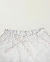 Early Sunday, Roman Short in Ivory color, made from All Over Embroidery fabric, featuring a relaxed fit with an elastic waistband & beautiful embroidery, shown in a closeup flat-lay view