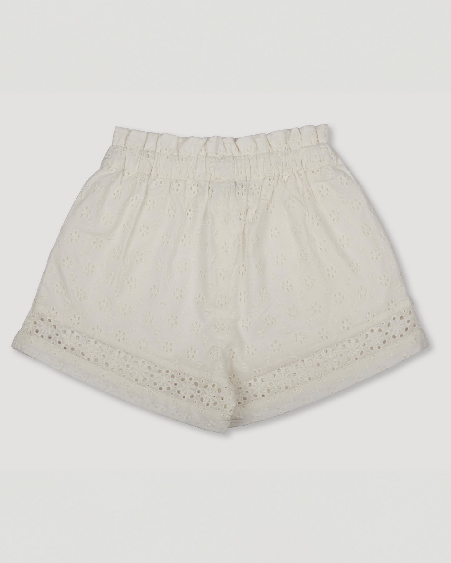 Early Sunday, Roman Shorts in Ivory color, made from All-Over Eyelet Embroidered Cotton Schifflie fabric, featuring relaxed fit with delicate finishes, combining style and functionality, shown in a back flat-lay view