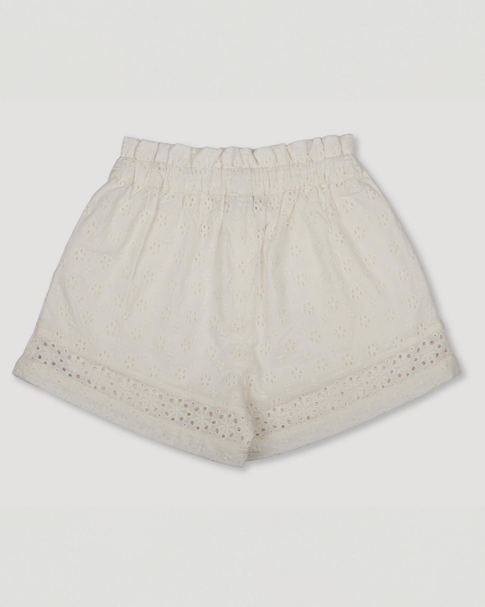 Early Sunday, Roman Shorts in Ivory color, made from All-Over Eyelet Embroidered Cotton Schifflie fabric, featuring relaxed fit with delicate finishes, combining style and functionality, shown in a back flat-lay view