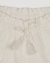 Early Sunday, Roman Shorts in Ivory color, made from All-Over Eyelet Embroidered Cotton Schifflie fabric, featuring relaxed fit with delicate finishes, combining style and functionality, shown in a closeup flat-lay view