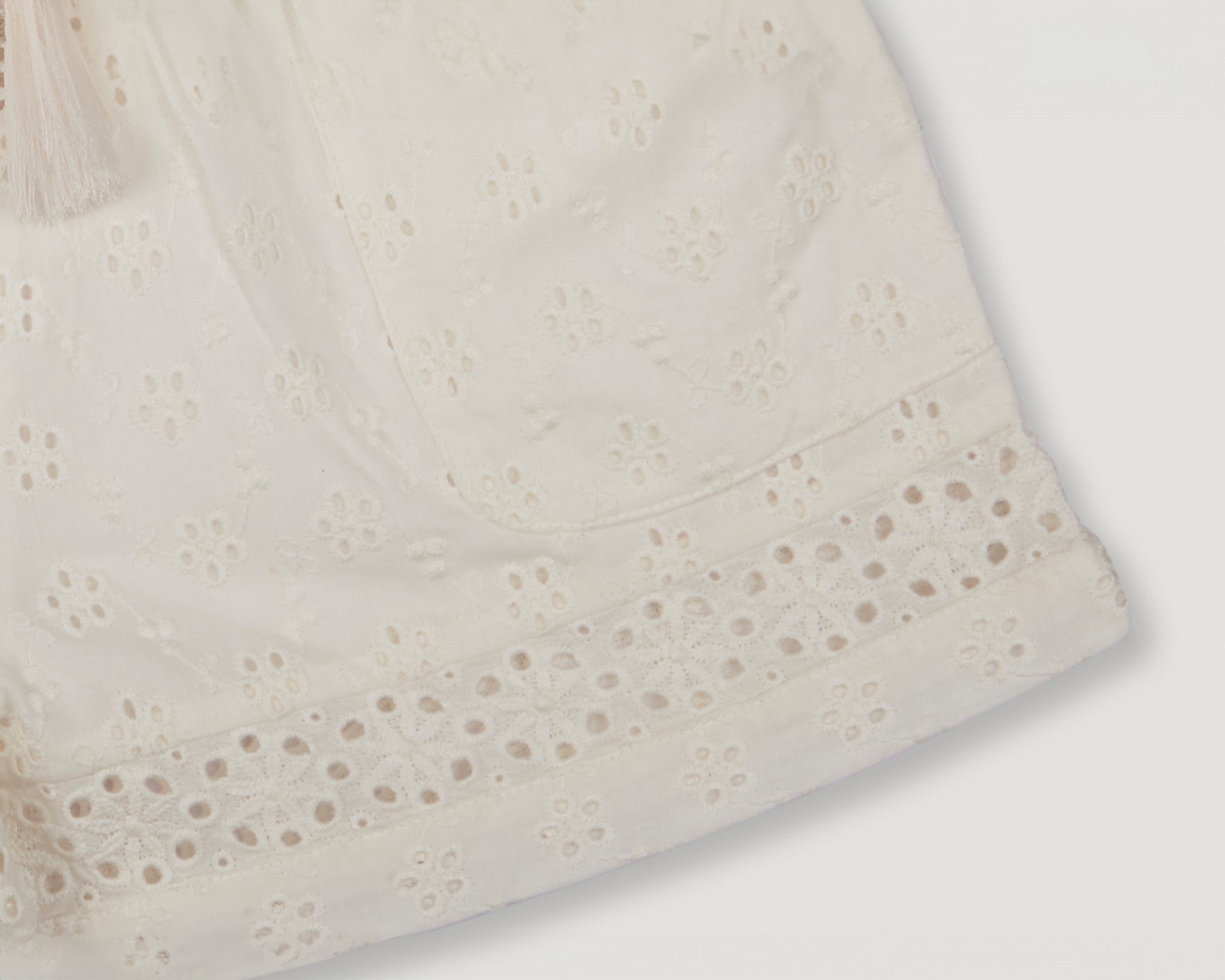 Early Sunday, Roman Shorts in Ivory color, made from All-Over Eyelet Embroidered Cotton Schifflie fabric, featuring relaxed fit with delicate finishes, combining style and functionality, shown in a detail flat-lay view