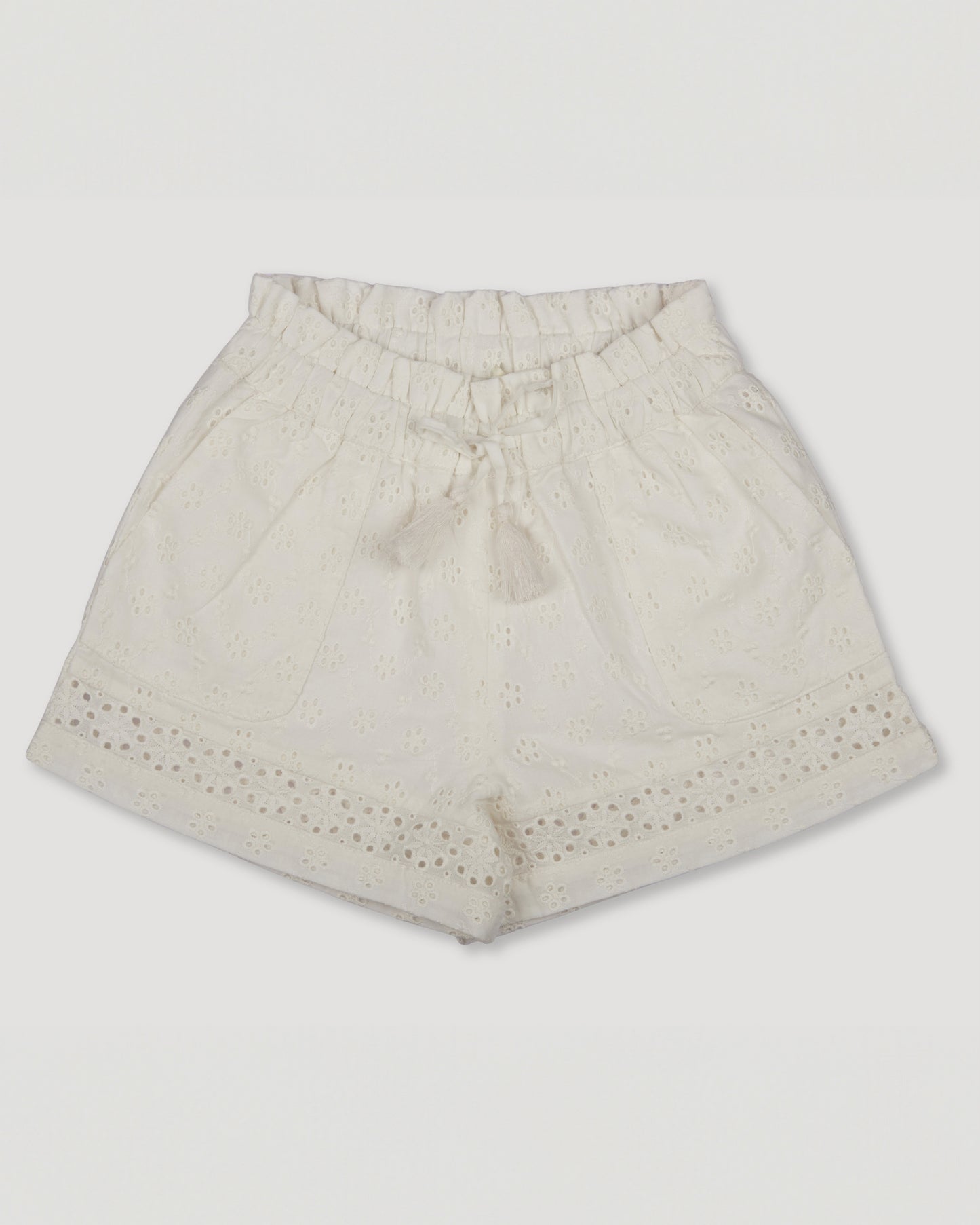 Early Sunday, Roman Shorts in Ivory color, made from All-Over Eyelet Embroidered Cotton Schifflie fabric, featuring relaxed fit with delicate finishes, combining style and functionality, shown in a front flat-lay view