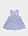 Early Sunday, Romy Blouse in Summer Sky color, made from  100% Cotton Chambray fabric, featuring a sleeveless design with cross-back straps, a gathered waist & a beautiful embroidery, shown in a front flat-lay view