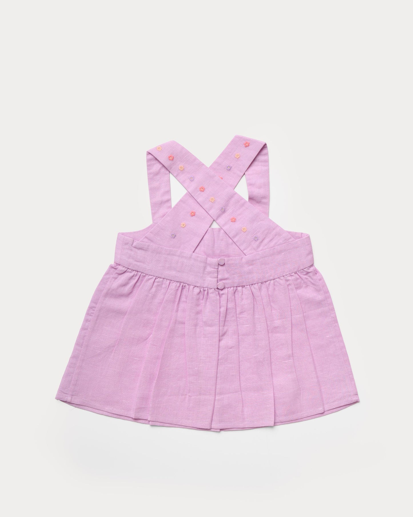 Early Sunday, Romy Blouse in Lilac color, made from 70% Cotton 30% Linen fabric, featuring a sleeveless design with cross-back straps, a gathered waist & a beautiful embroidery, shown in a back flat-lay view