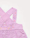 Early Sunday, Romy Blouse in Lilac color, made from 70% Cotton 30% Linen fabric, featuring a sleeveless design with cross-back straps, a gathered waist & a beautiful embroidery, shown in a closeup flat-lay view