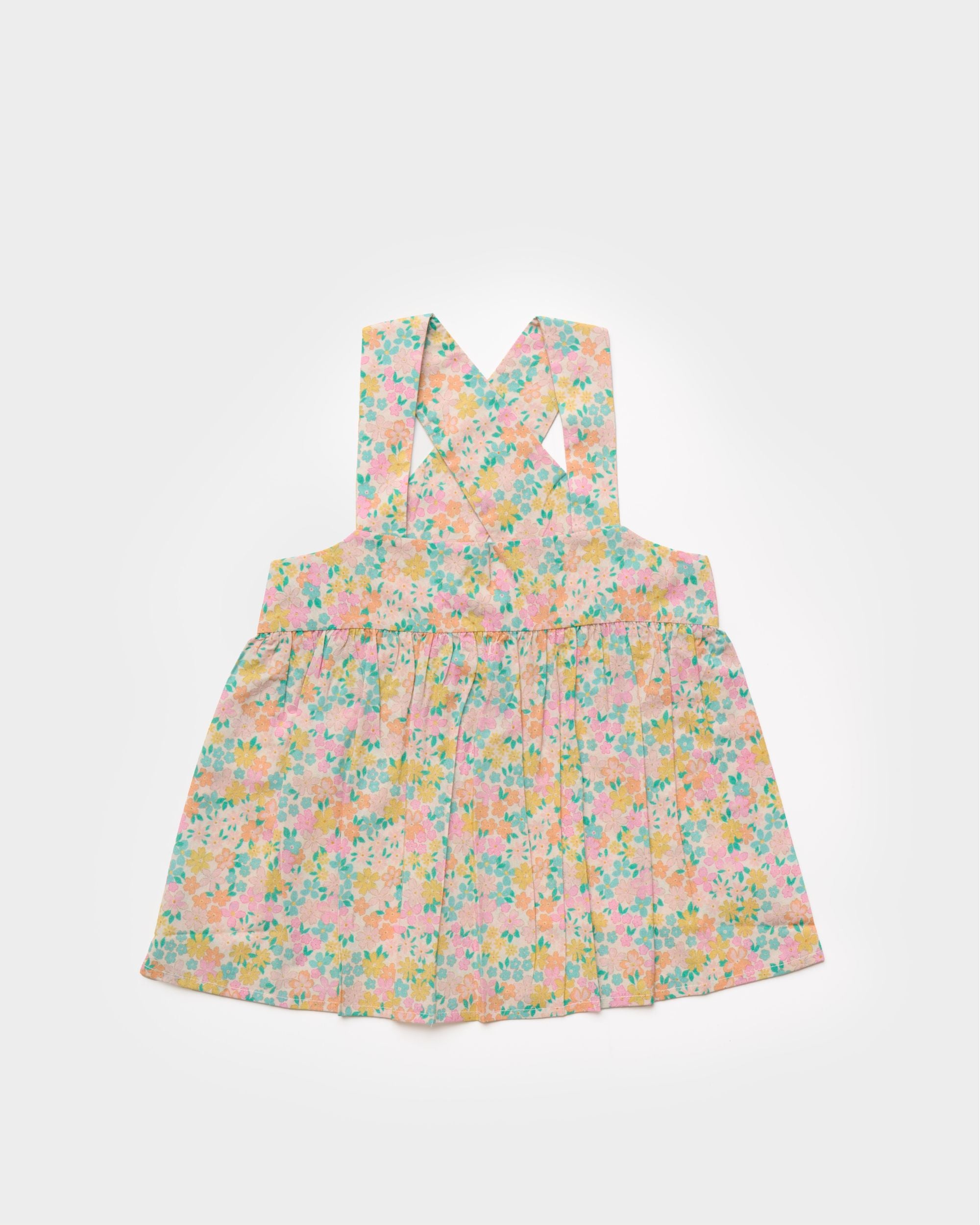 Early Sunday, Romy Blouse in Emma Floral Mint color, made from Organic Printed 60s Cotton Cambric fabric, featuring a sleeveless design with cross-back straps, a gathered waist & a soft flared silhouette, shown in a front flat-lay view
