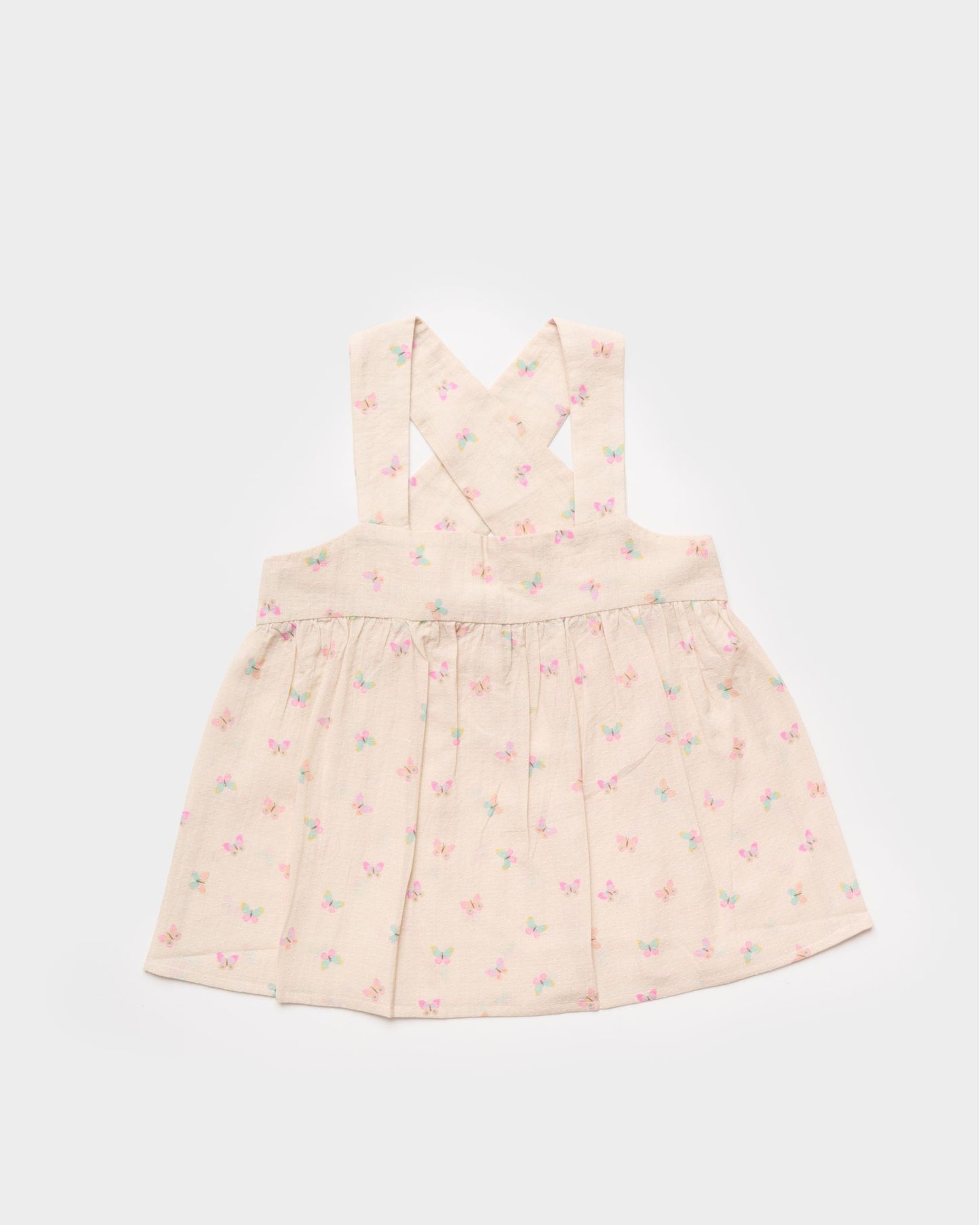 Early Sunday, Romy Blouse in Butterflies print, made from Printed Cotton Tiny Swiss Dobby fabric, featuring a sleeveless design with cross-back straps, a gathered waist & a soft flared silhouette, shown in front flat-lay view