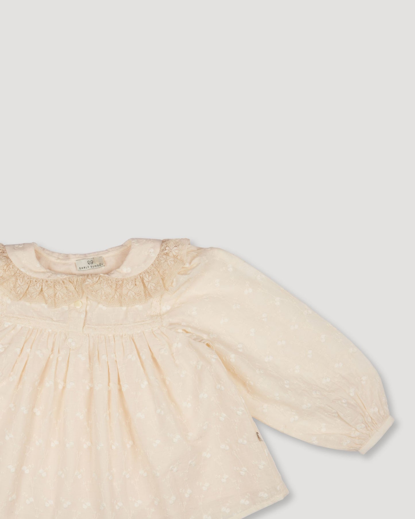 Early Sunday, Rosa Blouse in Hazelnut Cream, made from All-Over Embroidered Cotton Cambric fabric, featuring Frilled neckline detailed with a lace collar for a vintage touch, shown in a closeup flat-lay view